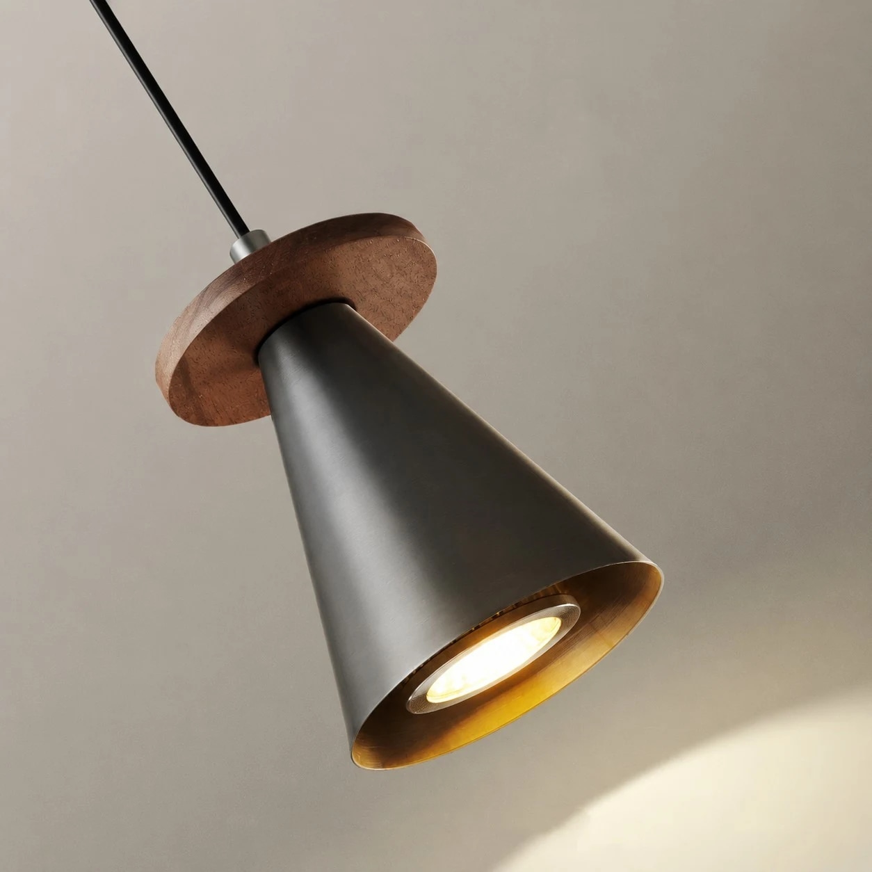 Black cone pendant light with walnut wood accent close-up
