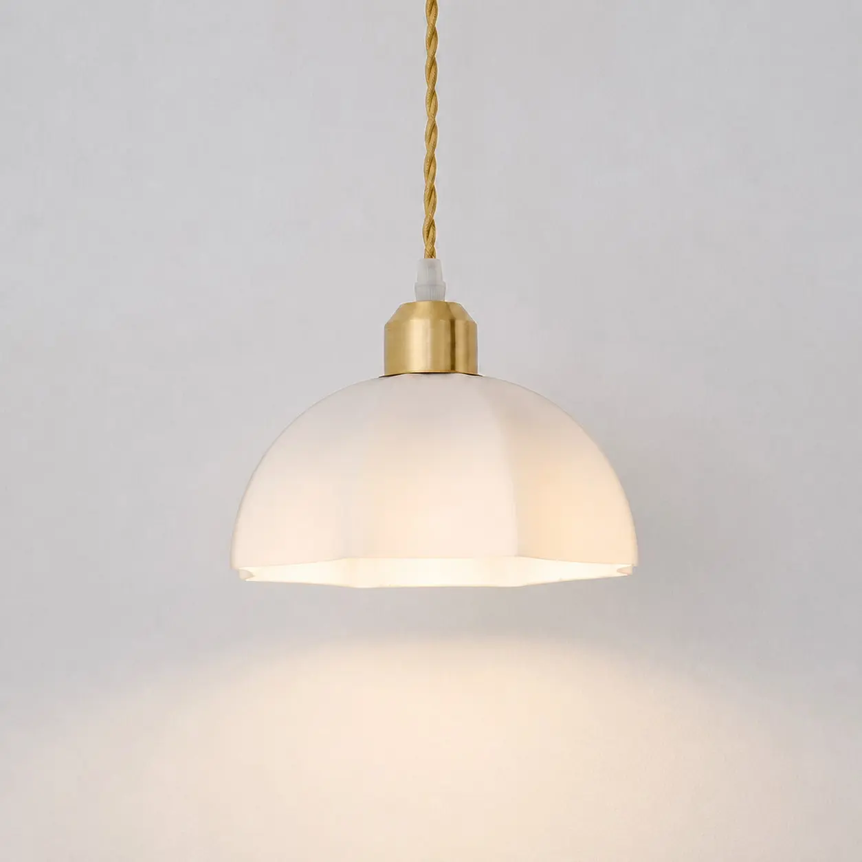 Milk glass pendant light in an illuminated room